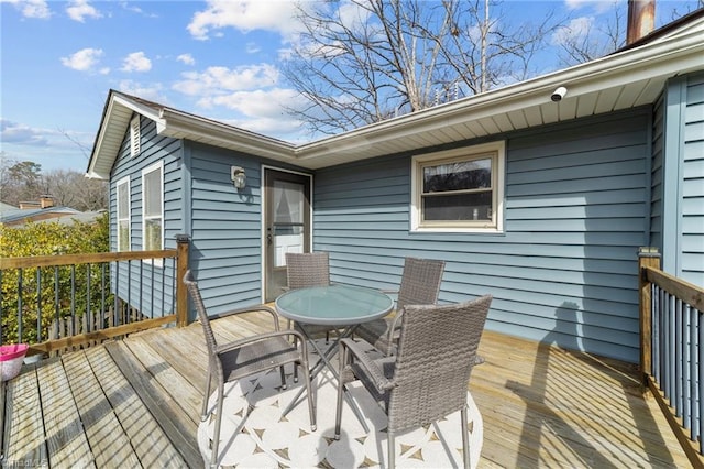 wooden deck featuring outdoor dining area