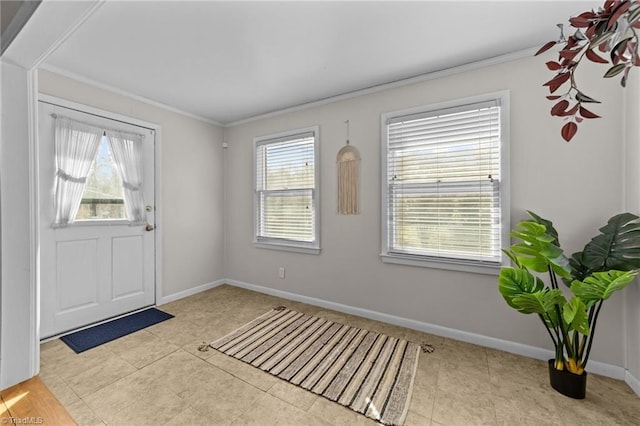 entrance foyer with tile patterned floors, baseboards, and ornamental molding