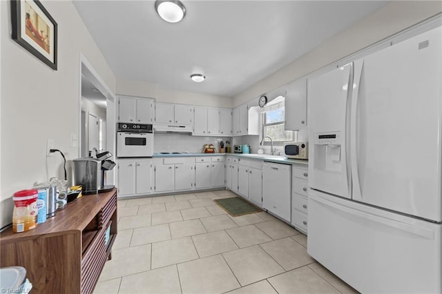 kitchen with decorative backsplash, white cabinets, a sink, white appliances, and under cabinet range hood