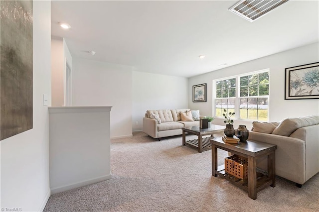 living area featuring visible vents, recessed lighting, baseboards, and light colored carpet