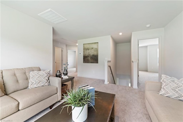 carpeted living area featuring visible vents and recessed lighting