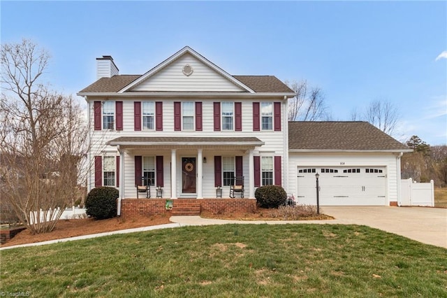 colonial house featuring a garage, concrete driveway, a chimney, a porch, and a front lawn