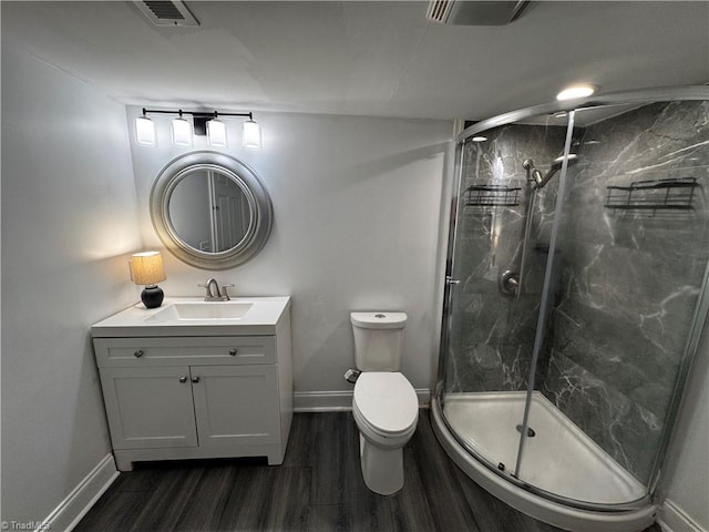 bathroom featuring vanity, wood-type flooring, an enclosed shower, and toilet