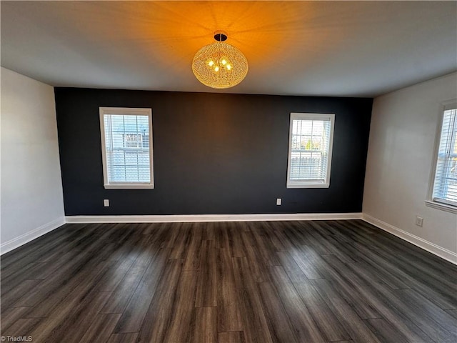 unfurnished room with dark wood-type flooring