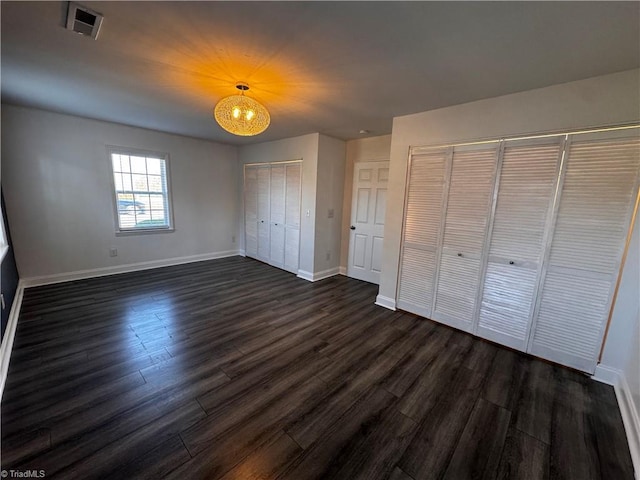 unfurnished bedroom featuring dark hardwood / wood-style floors