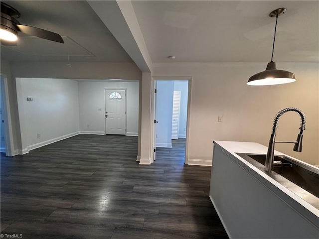 kitchen featuring ceiling fan, pendant lighting, and dark wood-type flooring