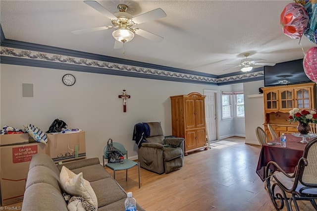 1401 Bretton St, Winston-Salem, NC 27105 - living area featuring ceiling fan, a textured ceiling, baseboards, wood finished floors, and ornamental molding