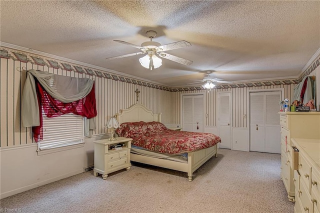 1401 Bretton St, Winston-Salem, NC 27105 - bedroom with a textured ceiling, light carpet, two closets, crown molding, and wallpapered walls