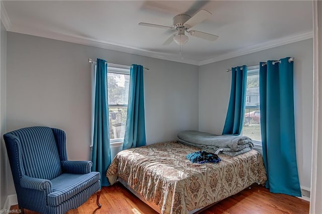 1401 Bretton St, Winston-Salem, NC 27105 - bedroom featuring multiple windows, crown molding, wood finished floors, and a ceiling fan