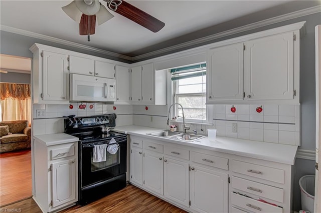 1401 Bretton St, Winston-Salem, NC 27105 - kitchen featuring black electric range oven, white microwave, a sink, a ceiling fan, and white cabinets