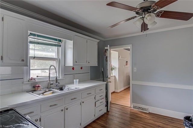 1401 Bretton St, Winston-Salem, NC 27105 - kitchen with a sink, white cabinets, tasteful backsplash, a ceiling fan, and dark wood finished floors