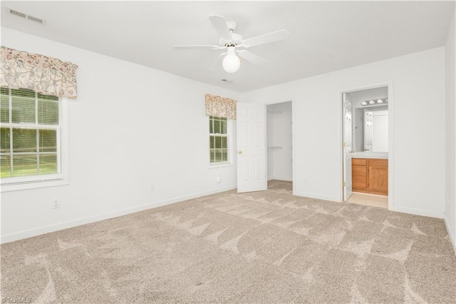 125 Haven Grove Trl, Clemmons, NC 27012 - unfurnished bedroom with light colored carpet, ensuite bath, a spacious closet, ceiling fan, and a closet