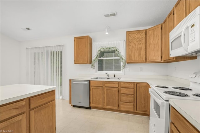 125 Haven Grove Trl, Clemmons, NC 27012 - kitchen with white appliances, light countertops, and brown cabinetry