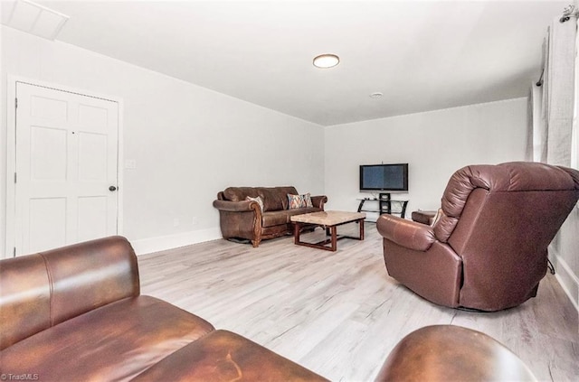 living area featuring light wood finished floors and baseboards