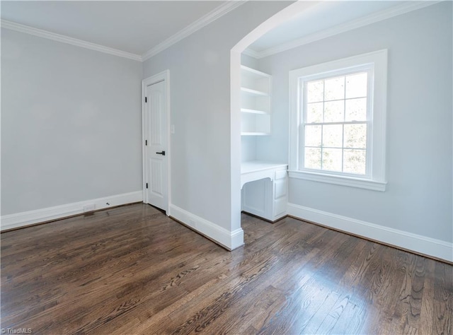 spare room with dark hardwood / wood-style floors and crown molding