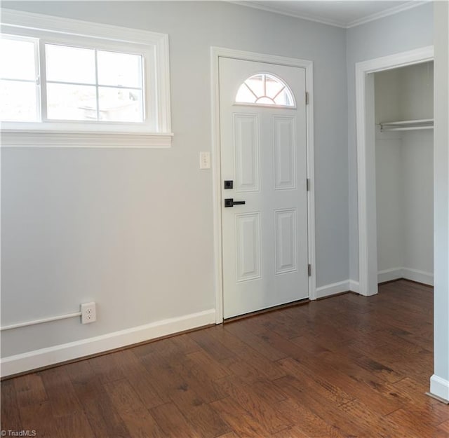 foyer entrance with dark hardwood / wood-style floors and ornamental molding