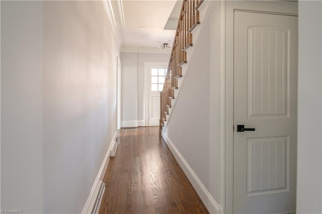 hall with dark hardwood / wood-style floors and crown molding