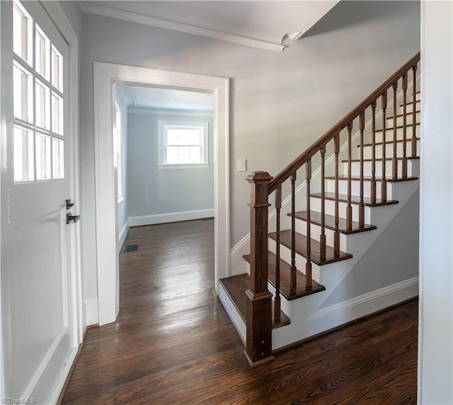 stairs with wood-type flooring and crown molding