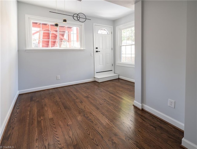 entrance foyer with dark hardwood / wood-style floors