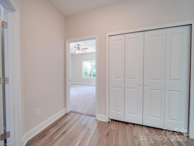 unfurnished bedroom featuring light hardwood / wood-style floors and a closet