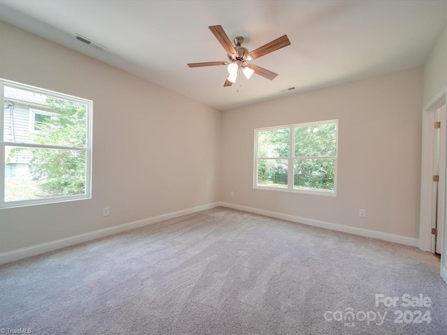 unfurnished room featuring light colored carpet and ceiling fan