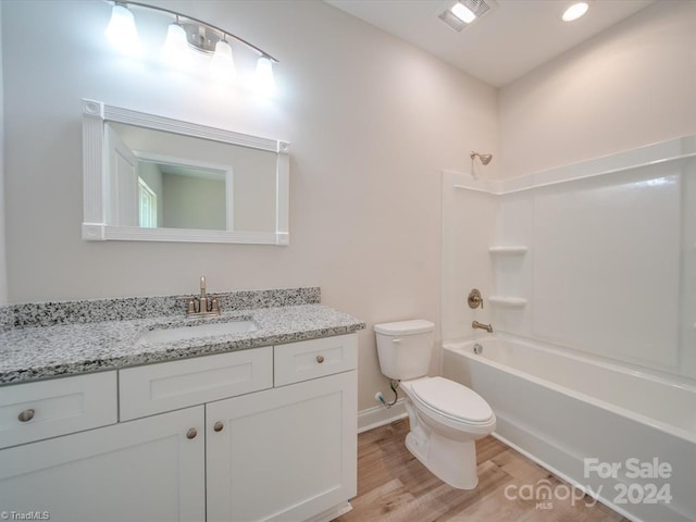 full bathroom with vanity, toilet, wood-type flooring, and bathtub / shower combination