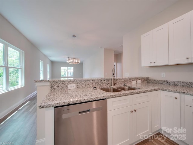 kitchen featuring white cabinets, pendant lighting, stainless steel dishwasher, and sink