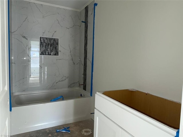 bathroom with ornamental molding and tiled shower / bath