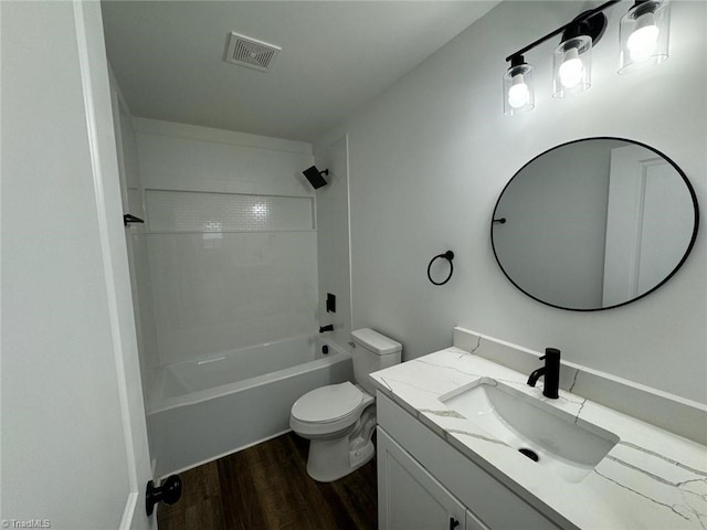 full bathroom featuring toilet, hardwood / wood-style floors, vanity, and washtub / shower combination