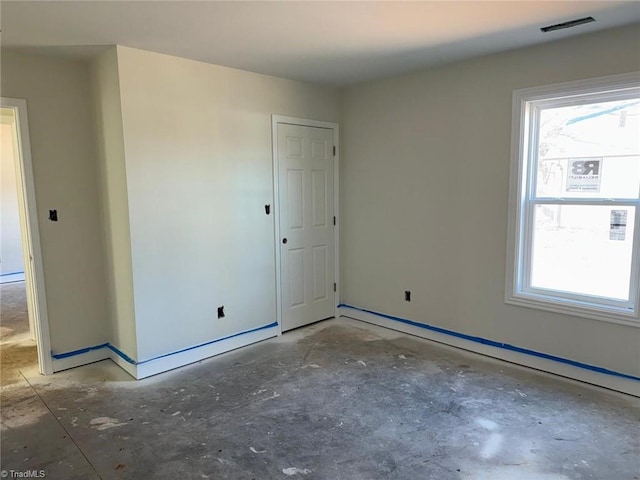 unfurnished room with baseboard heating