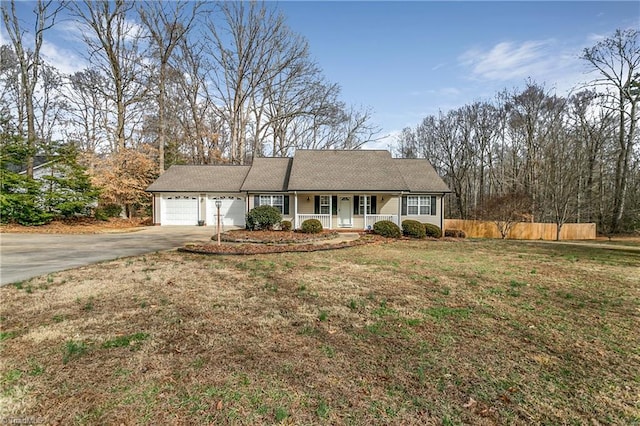 ranch-style home featuring a porch, a front yard, fence, a garage, and driveway