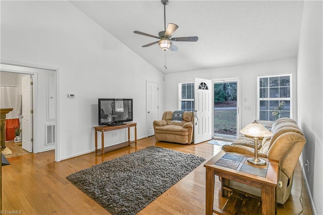 living room with high vaulted ceiling, ceiling fan, visible vents, and wood finished floors