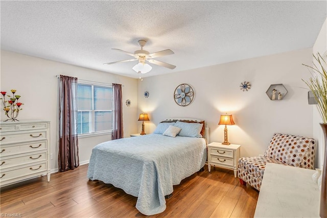 bedroom featuring a textured ceiling, ceiling fan, and hardwood / wood-style flooring