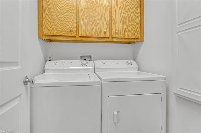 laundry room with washer and clothes dryer and cabinet space