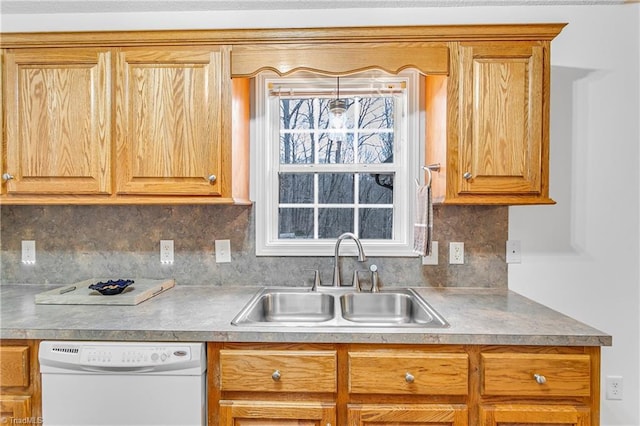 kitchen with a sink, tasteful backsplash, and dishwasher