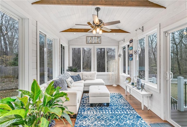 sunroom / solarium featuring vaulted ceiling with beams and a ceiling fan