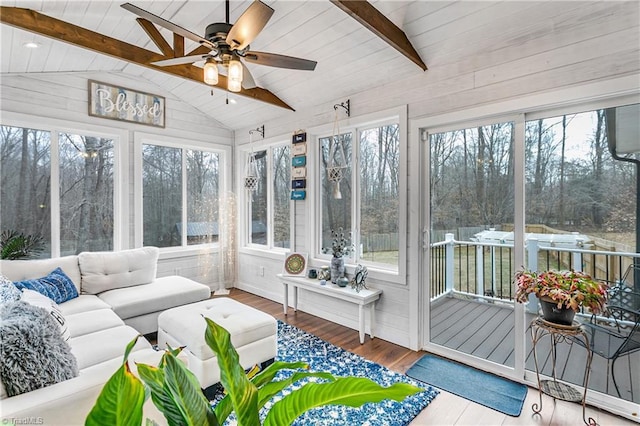 sunroom with a ceiling fan, wood ceiling, and vaulted ceiling with beams