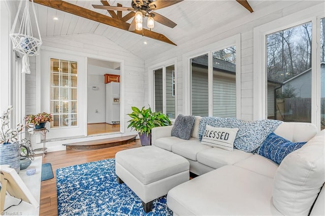 sunroom / solarium featuring lofted ceiling with beams and ceiling fan