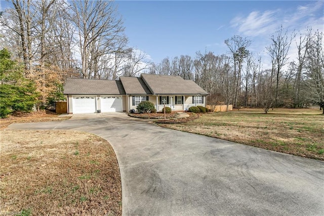 ranch-style house with a garage, a front yard, and driveway