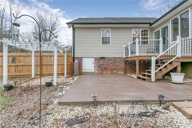 back of house featuring a patio area, fence, a deck, and stairs