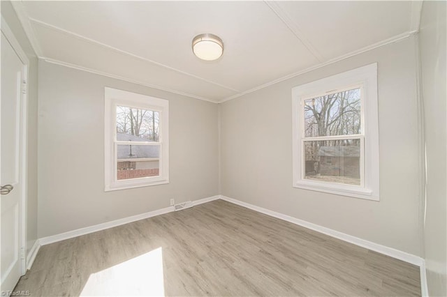 unfurnished room with light hardwood / wood-style flooring and ornamental molding