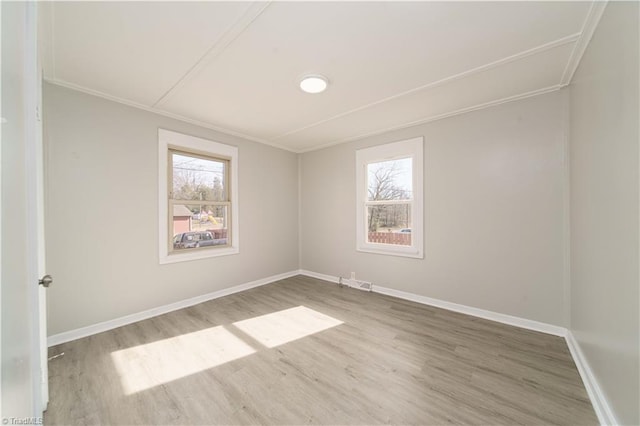 spare room with hardwood / wood-style flooring and ornamental molding