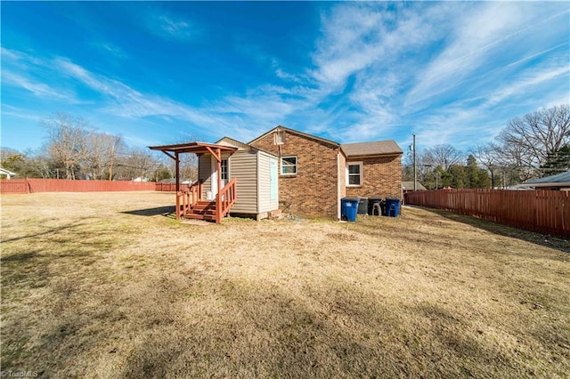 rear view of house featuring a lawn