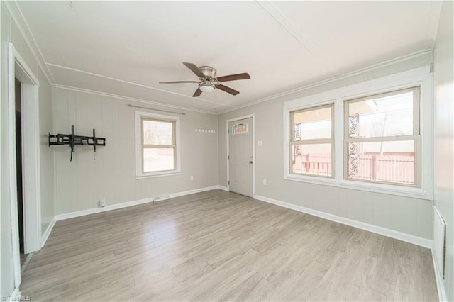 unfurnished room featuring ceiling fan, ornamental molding, and light hardwood / wood-style floors