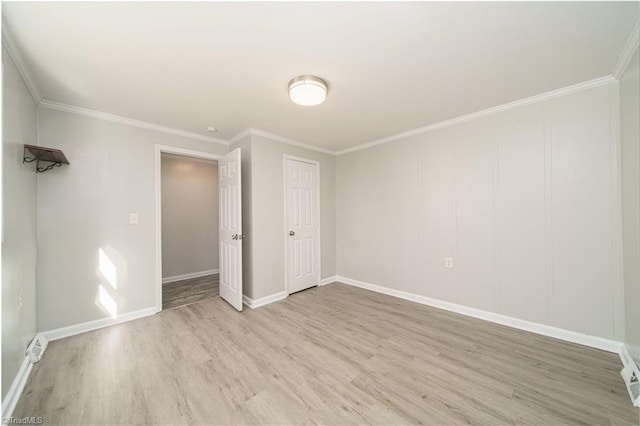 unfurnished bedroom with ornamental molding and light hardwood / wood-style floors