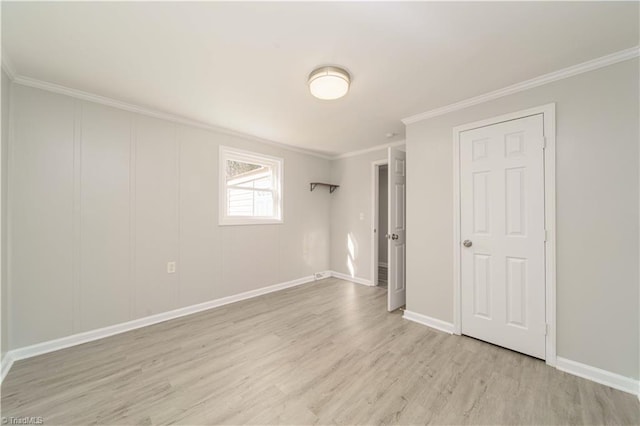 unfurnished bedroom featuring ornamental molding and light wood-type flooring