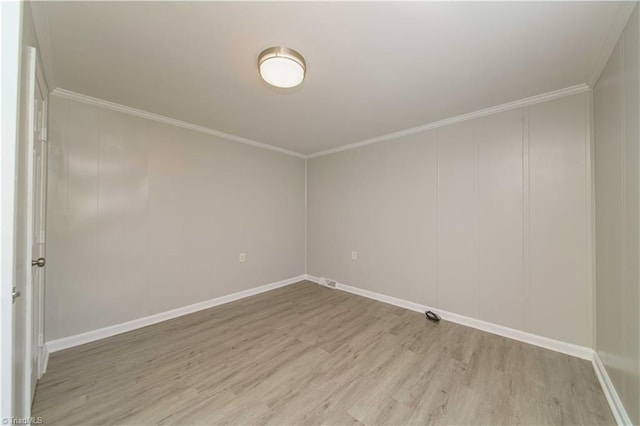 spare room with ornamental molding and wood-type flooring