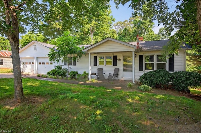 209 Brewer Cir, East Bend, NC 27018 - single story home featuring a porch, a chimney, a garage, and a front yard