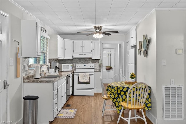 209 Brewer Cir, East Bend, NC 27018 - kitchen with white appliances, ceiling fan, decorative backsplash, wood finished floors, and white cabinetry