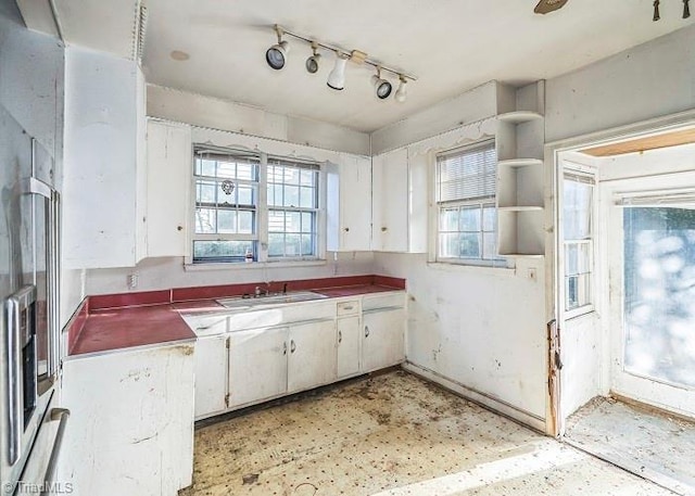 kitchen with white cabinetry and sink